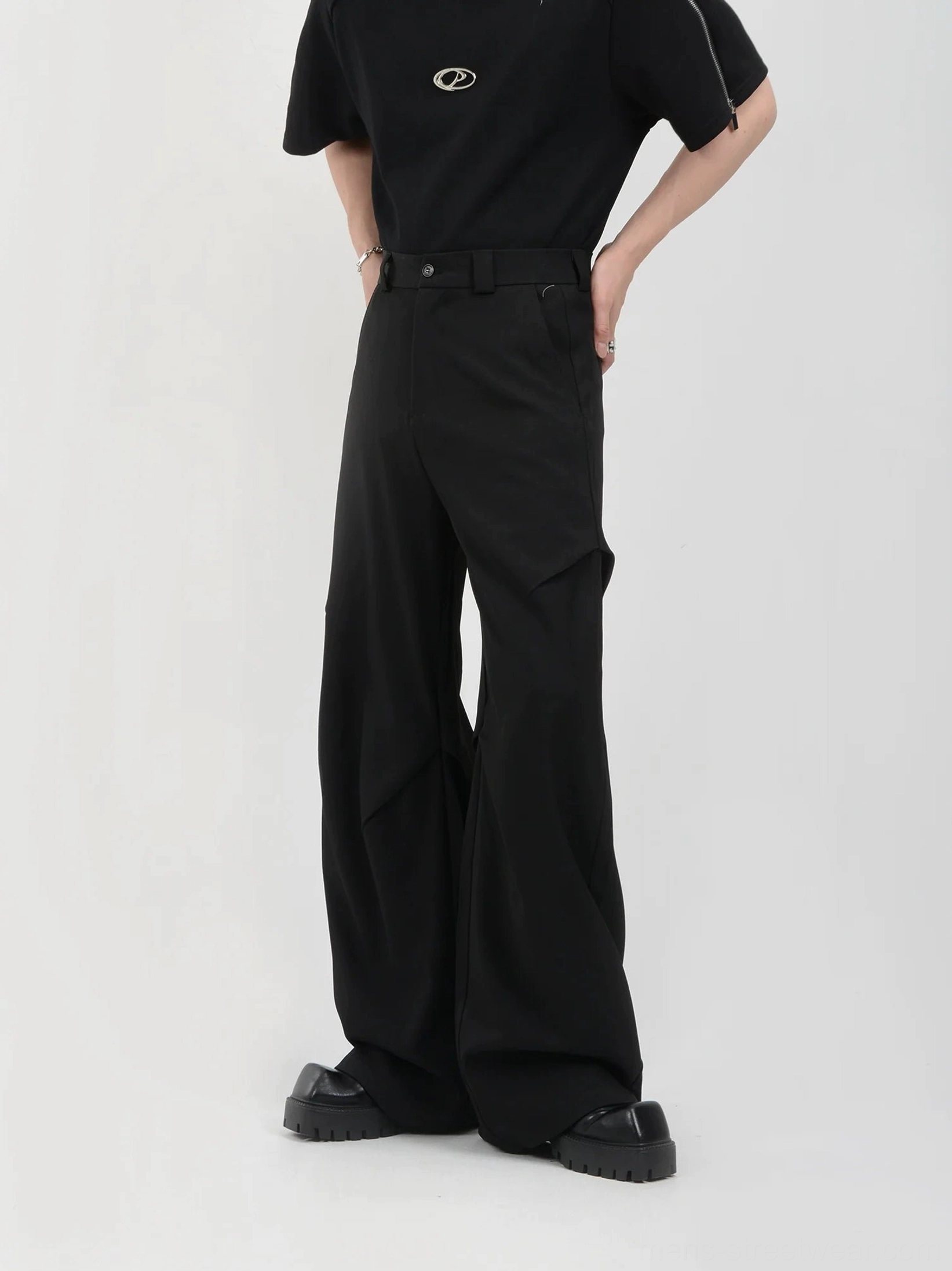 Black high-waisted wide-leg streetwear trousers side view showing tailored drape and side pocket
