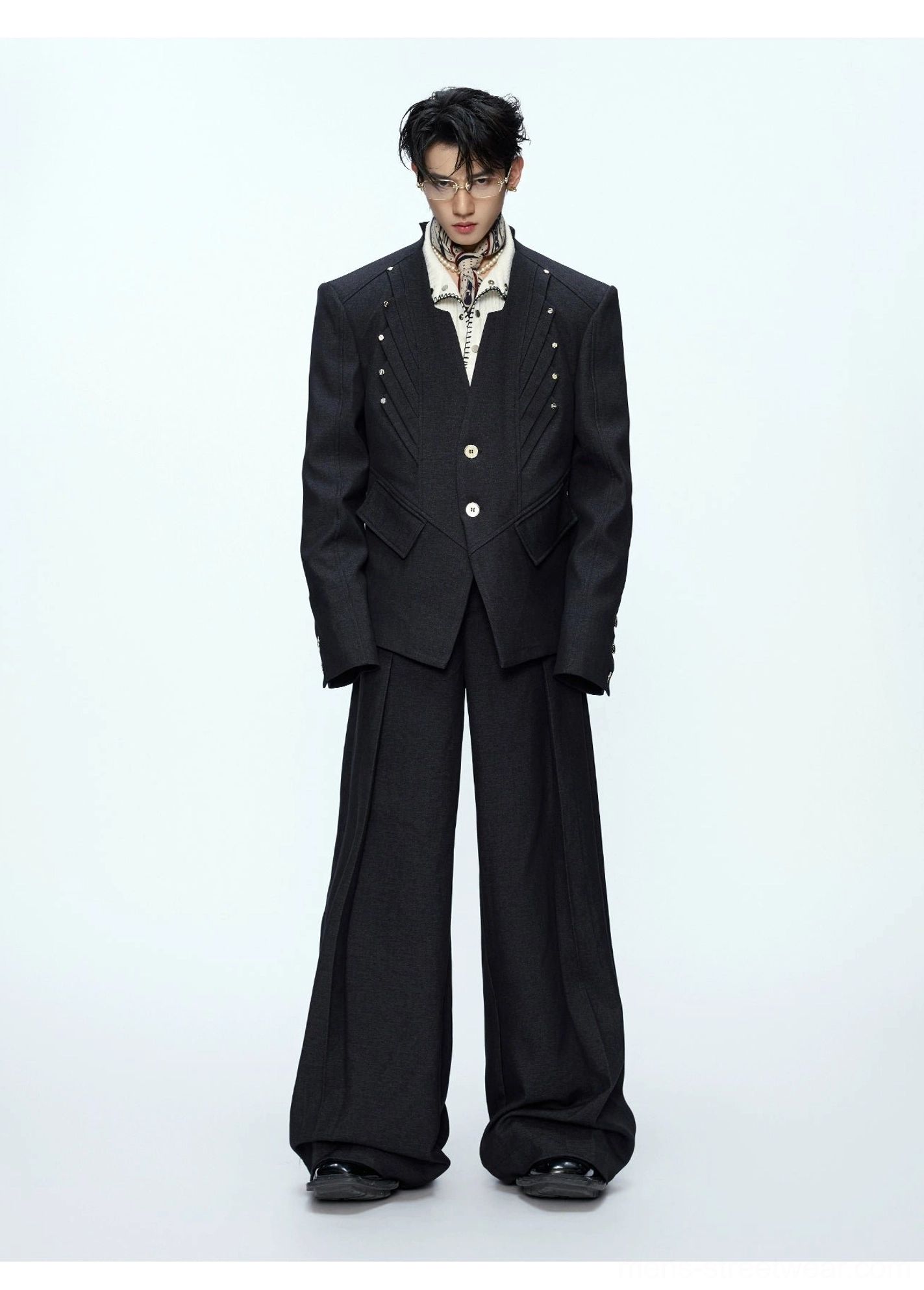 Black high-waisted wide-leg trousers and oversized tailored blazer with metal stud details front view