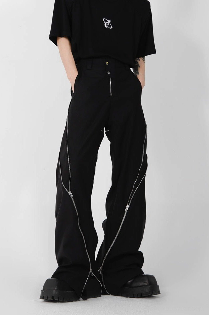 Black high-waisted zipper slit trousers shown from a three-quarter front angle with decorative side zippers, relaxed wide legs, and platform footwear