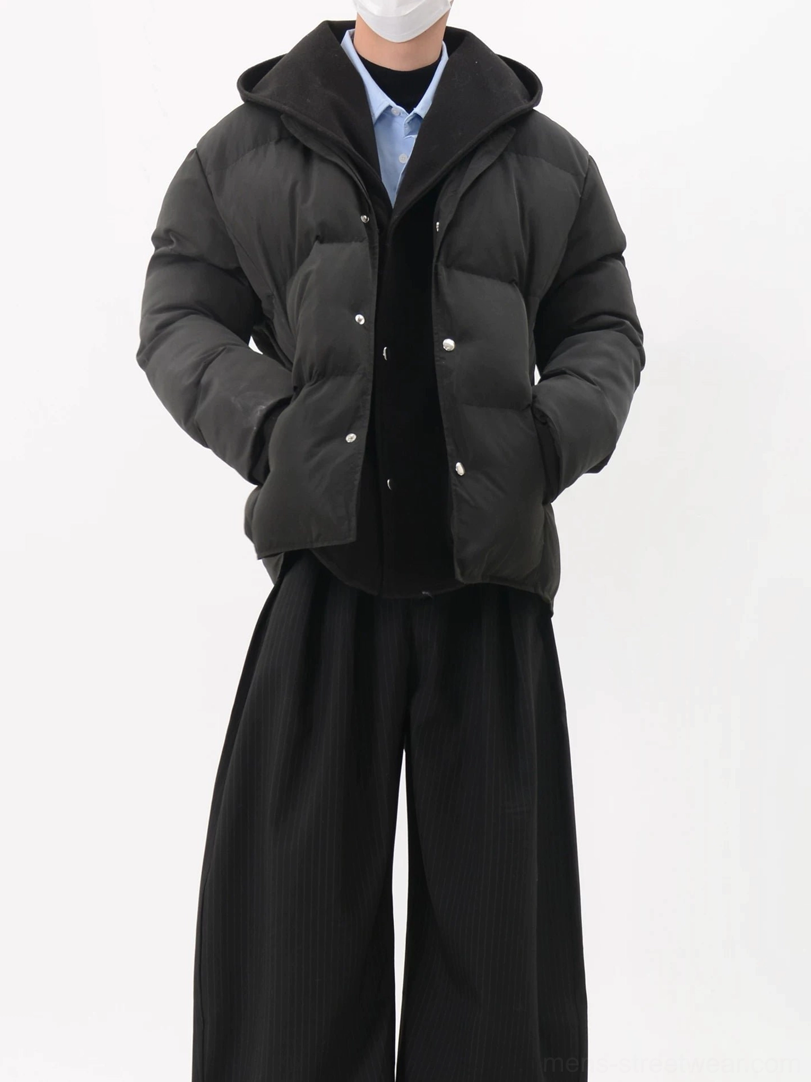 Black hooded snap-button puffer jacket with oversized hood matte finish and relaxed cropped streetwear fit