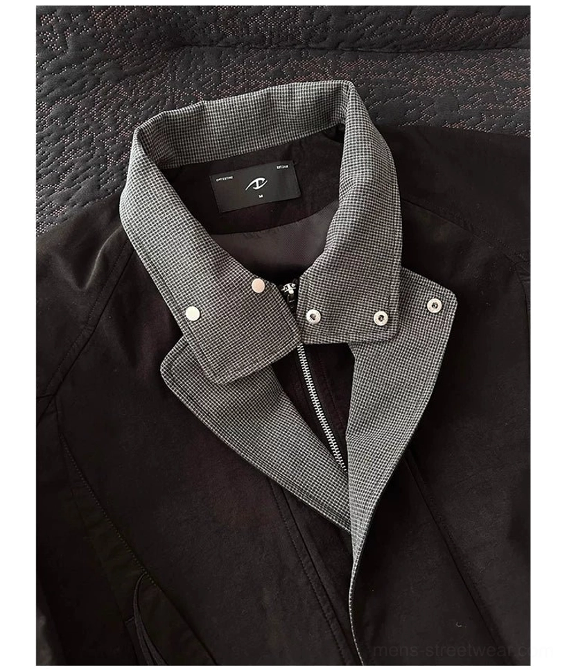 Close-up detail of black houndstooth double-collar bomber jacket showing snap buttons, inner placket, zipper closure, and collar construction