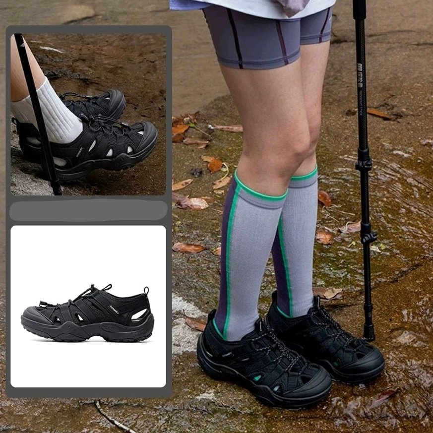 Black hybrid hiking sandals styled with tall striped socks and hiking shorts on a wet leaf-covered rocky trail, with close-up and flat-lay views