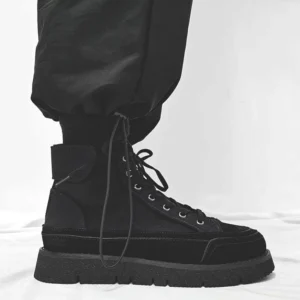 Black high-top Japanese streetwear work boots with mixed suede and canvas upper, chunky anti-slip rubber sole, and black tapered cargo pants