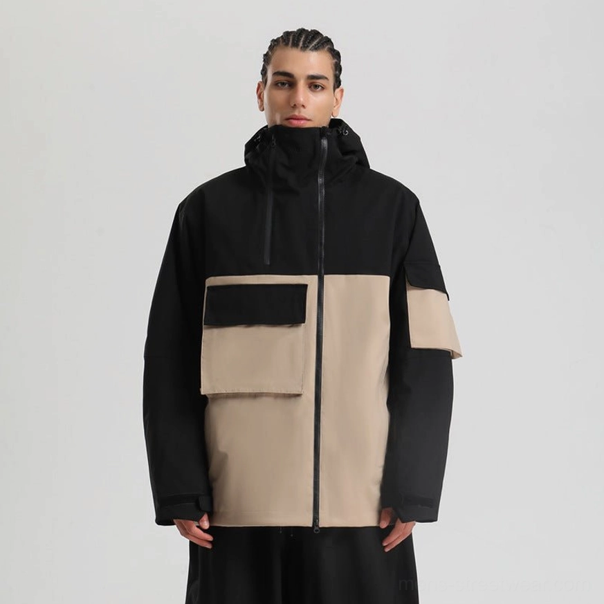 Black and khaki colorblock outdoor jacket with attached hood, large flap pockets, central zipper, and contrast sleeve utility pocket
