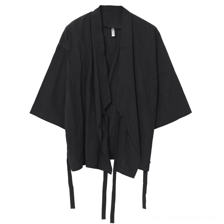 Black kimono-inspired streetwear shirt with relaxed oversized cut and versatile open-front layering design