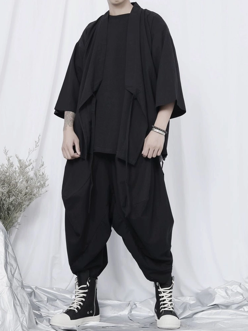 Full body black kimono shirt outfit with loose fit silhouette, hanging tie straps, solid woven fabric, and coordinated high-top shoes