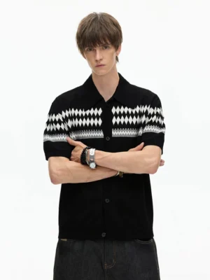 Front close-up of black short-sleeve knit button shirt with classic polo collar geometric Fair Isle chest and cuff details