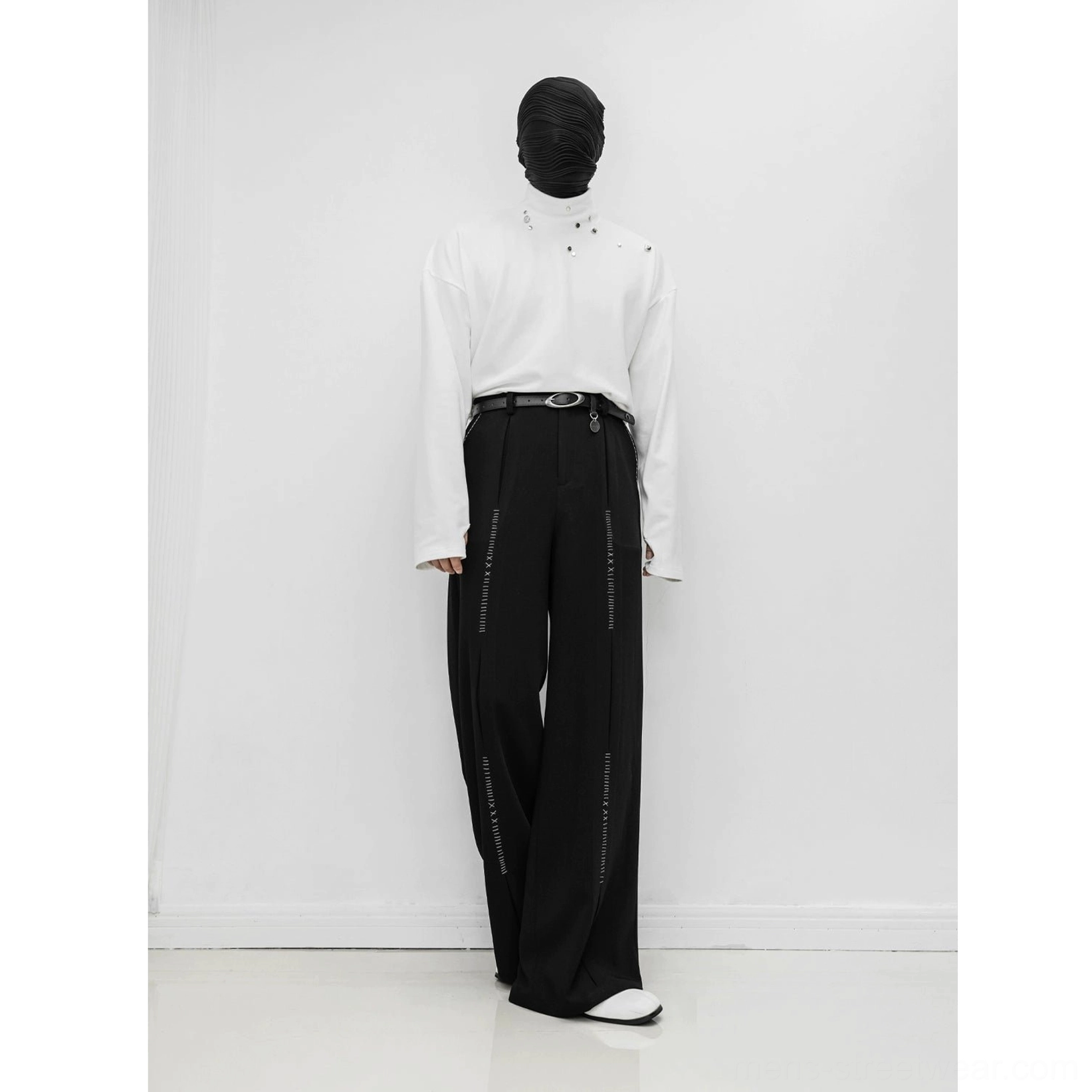 Black Korean-inspired wide-leg trousers shown in a full front view with smooth fabric drape and balanced decorative stitch lines on both legs