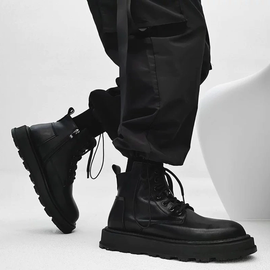 Black mid-top Korean streetwear combat boot worn with cargo pants showing side zipper, loose laces and chunky rubber platform outsole