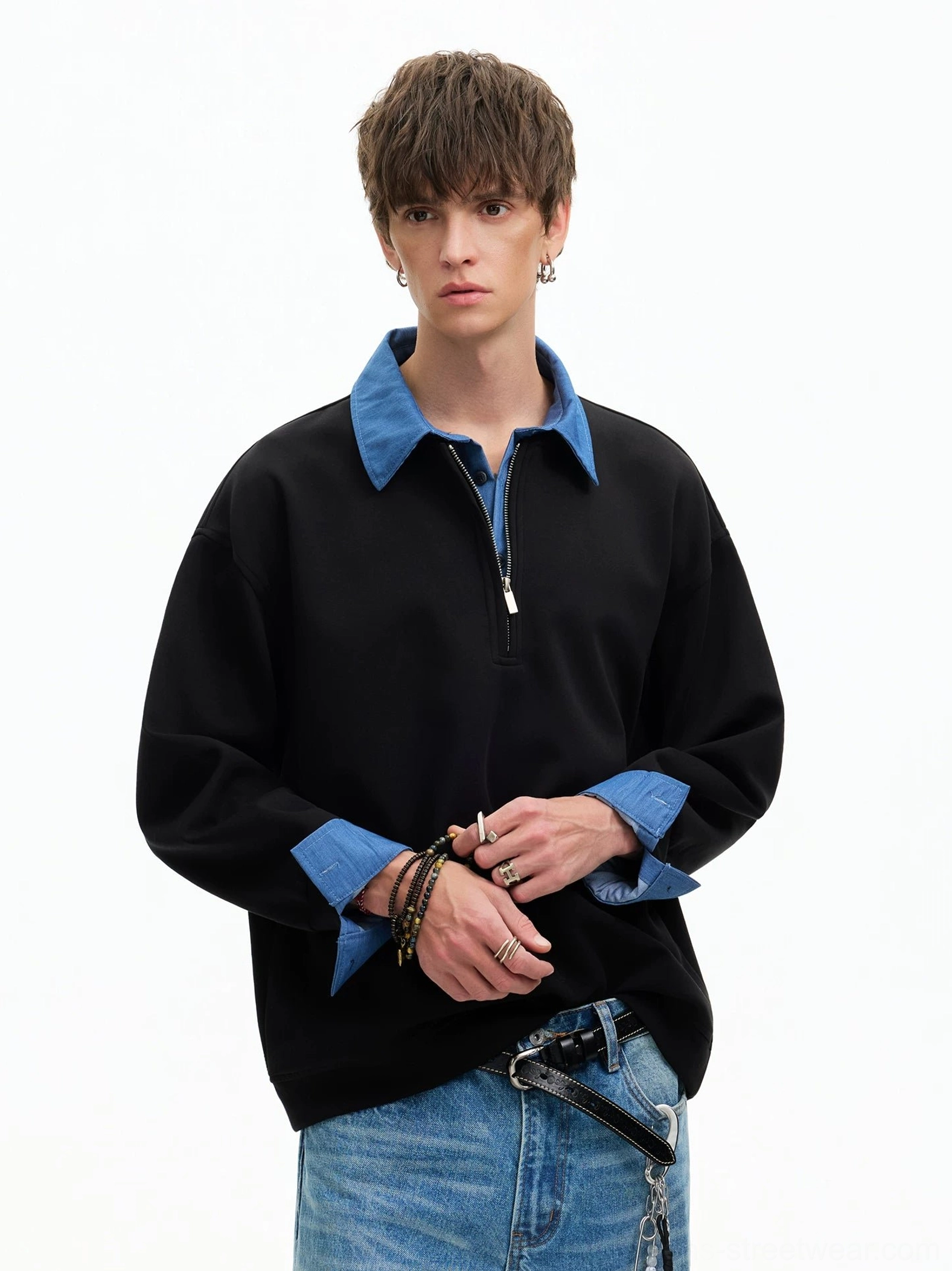 Black Korean streetwear half-zip sweatshirt with blue layered collar and cuffs styled with jeans and belt chain