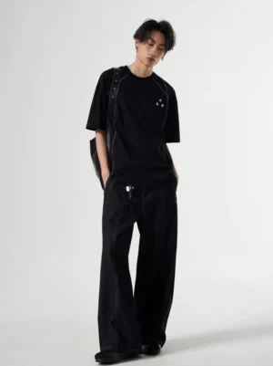 Black Korean streetwear relaxed T-shirt styled with wide-leg black denim pants and a crossbody bag