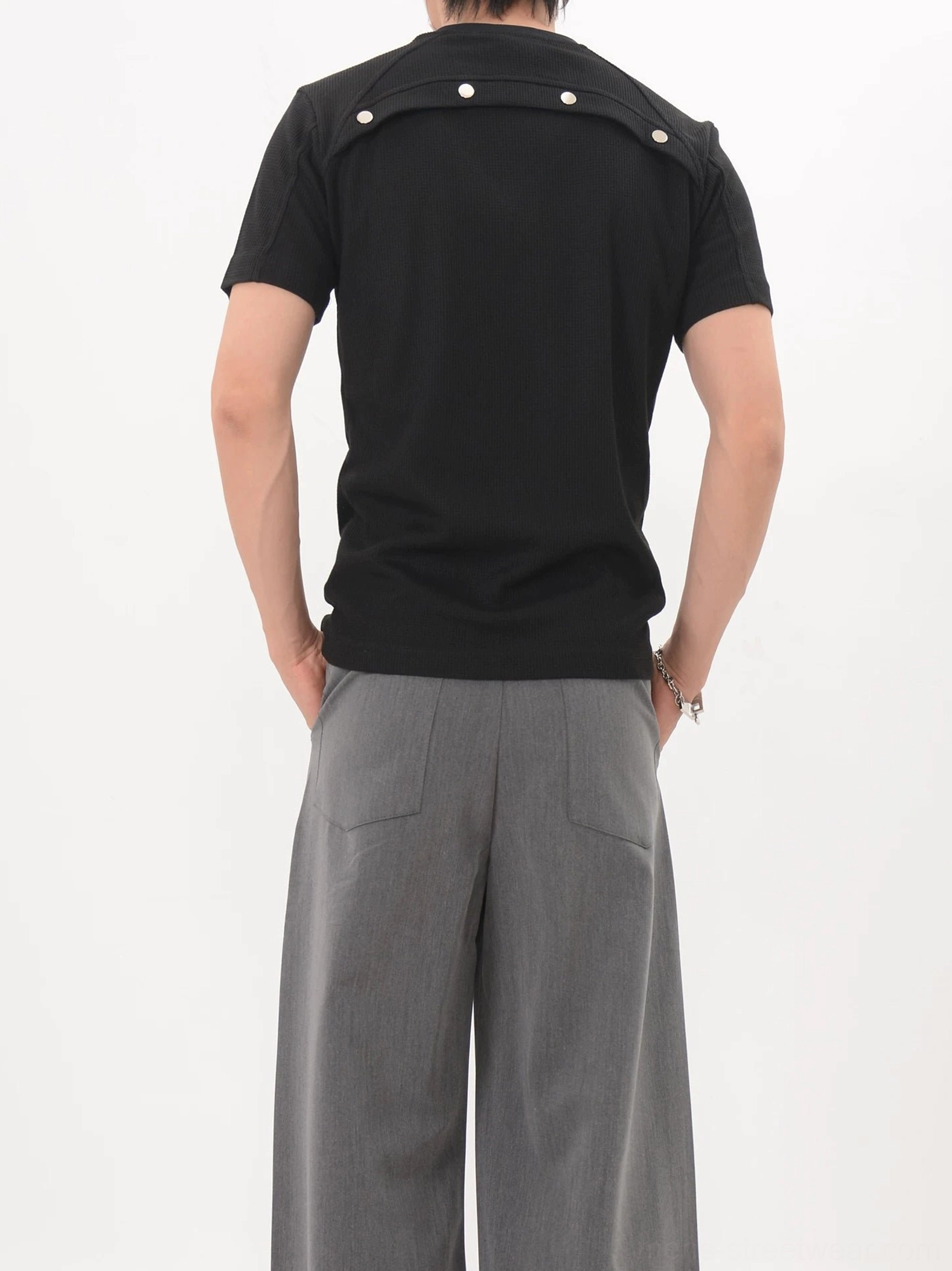 Black Korean streetwear knit tee shown from the back with shoulder snap details and clean solid-color fitted silhouette