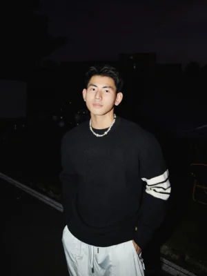 Black Korean streetwear crewneck striped sleeve sweater with contrasting white triple stripe detail, ribbed knit texture, and relaxed silhouette