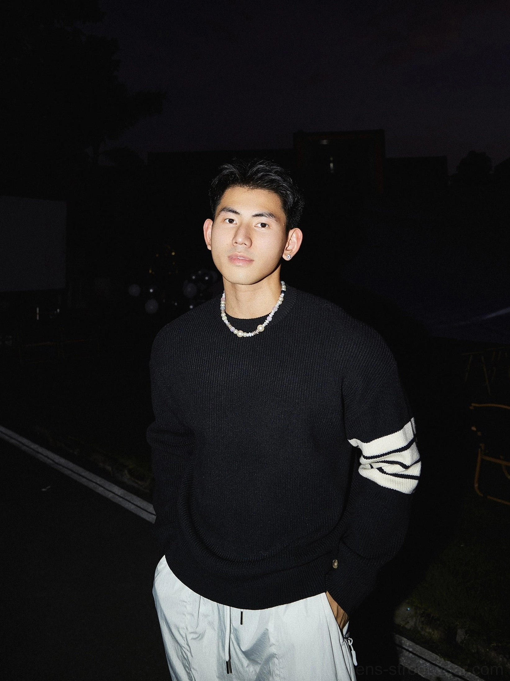 Black Korean streetwear crewneck striped sleeve sweater with contrasting white triple stripe detail, ribbed knit texture, and relaxed silhouette