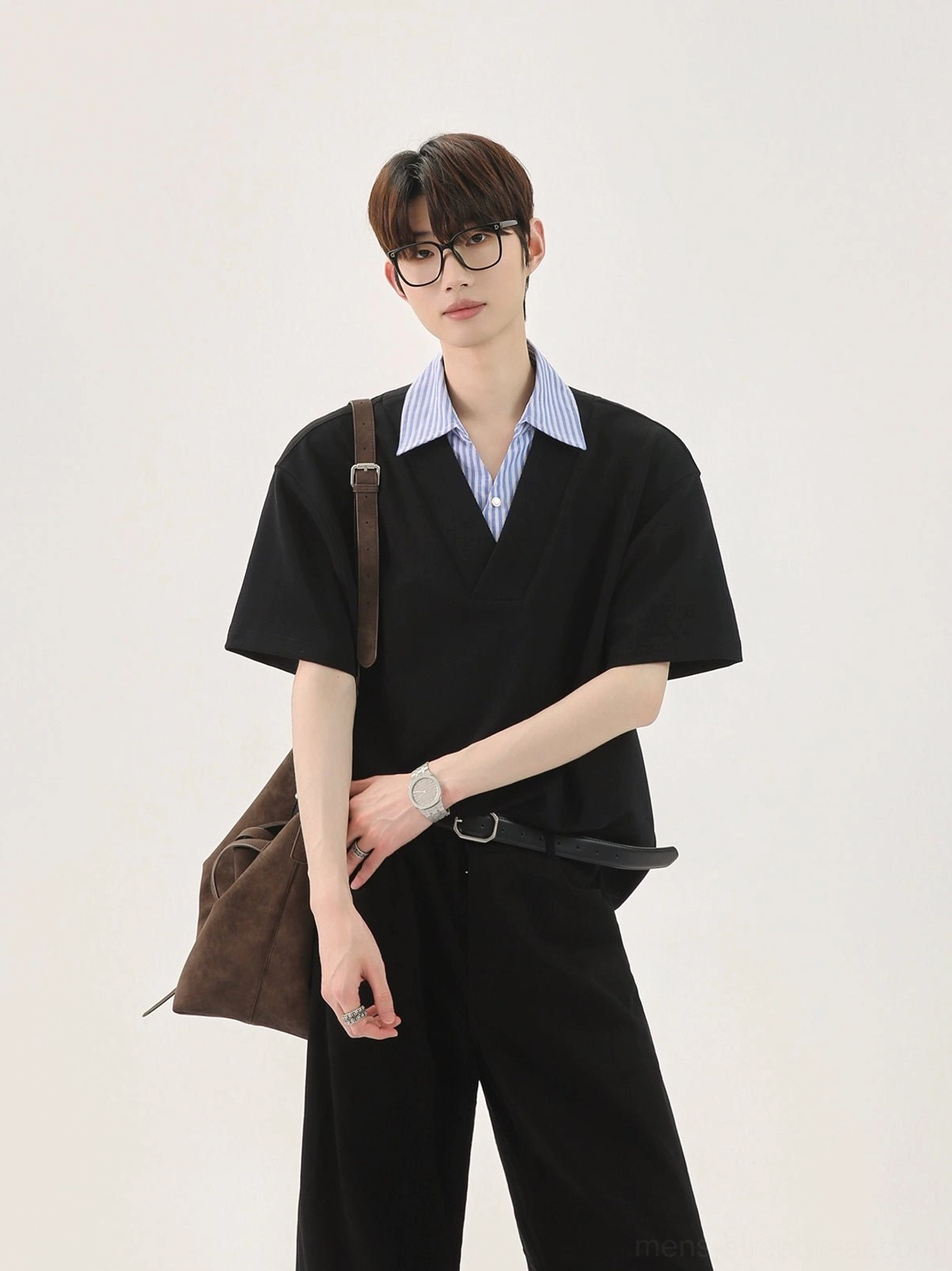 Half-body view of a black Korean streetwear T-shirt with faux blue striped shirt collar, V-neck placket, glasses, and crossbody bag