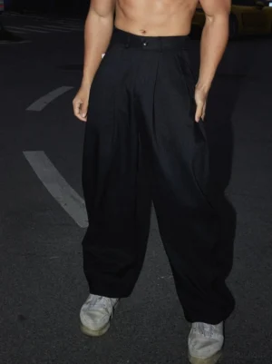 Black Korean streetwear wide-leg pleated trousers shown in a front low-angle full-body urban night road outfit with high waist and loose silhouette