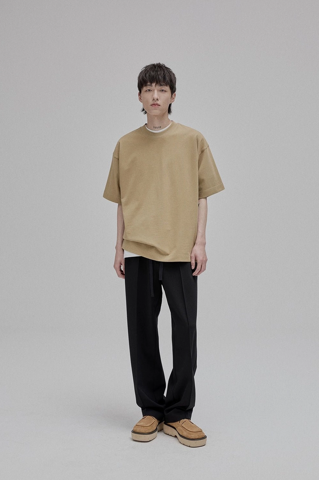 Black lace-up straight leg tapered trousers ankle detail fitted proportions minimalist styling