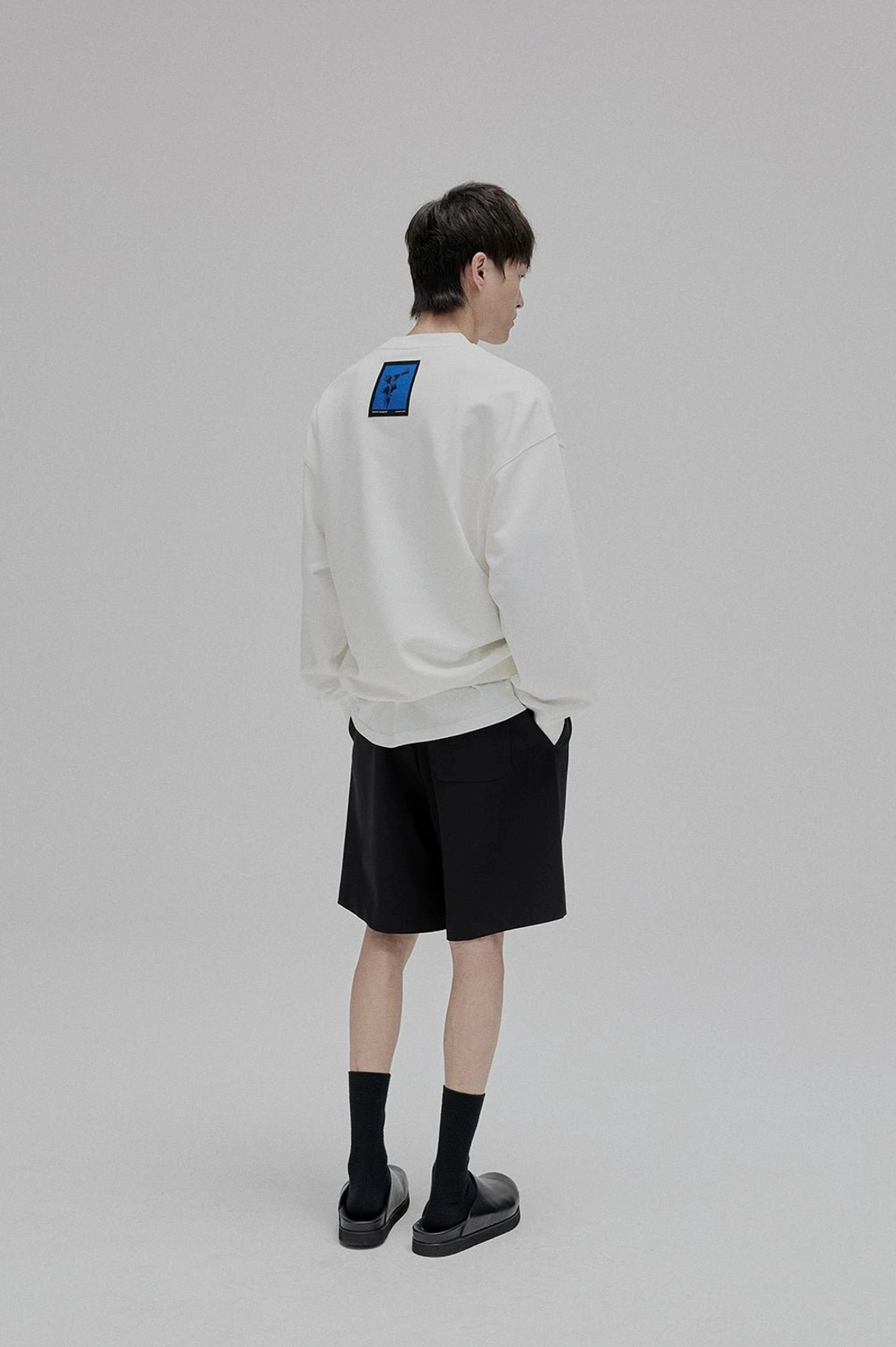 Black lace-up straight leg trousers side profile tapered ankle streetwear drape silhouette