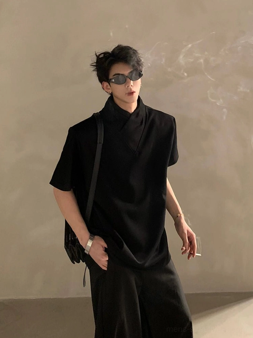 Black relaxed layered high-collar short-sleeve shirt styled with sunglasses and crossbody bag in modern streetwear look