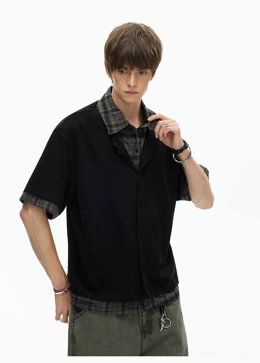 Black layered plaid hem knit shirt close-up featuring contrast plaid collar and relaxed boxy fit