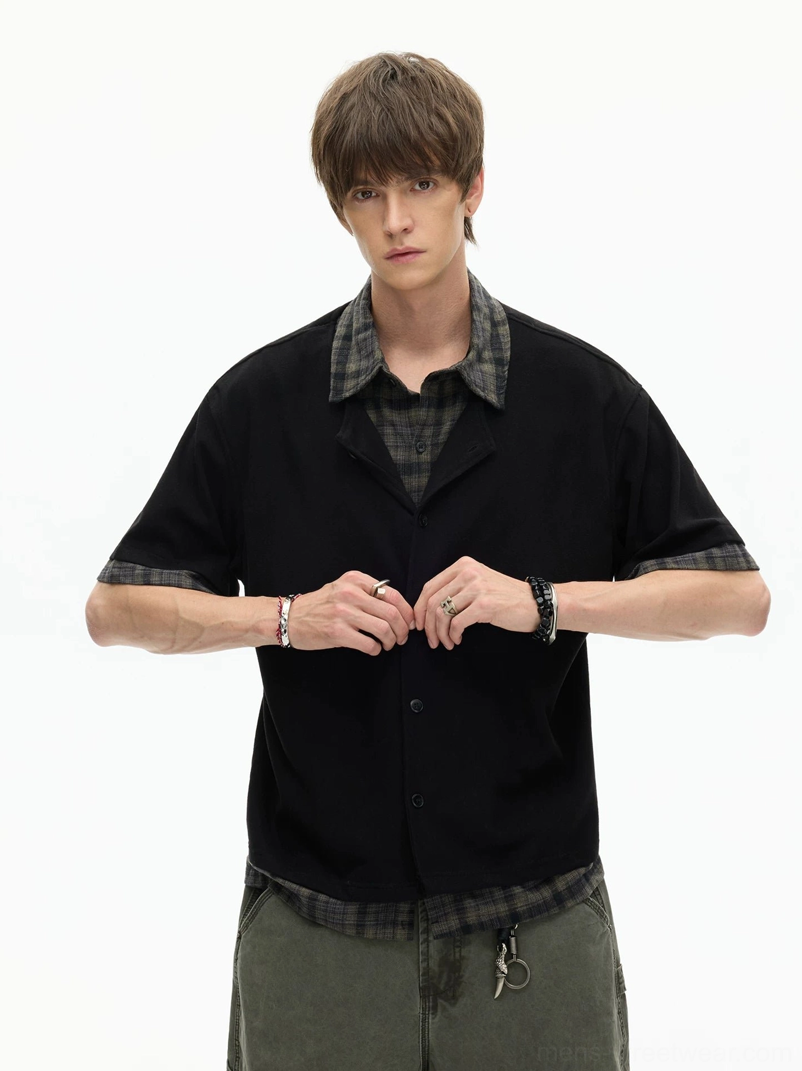 Black layered plaid hem knit shirt worn with olive cargo pants in a full-body Korean streetwear outfit