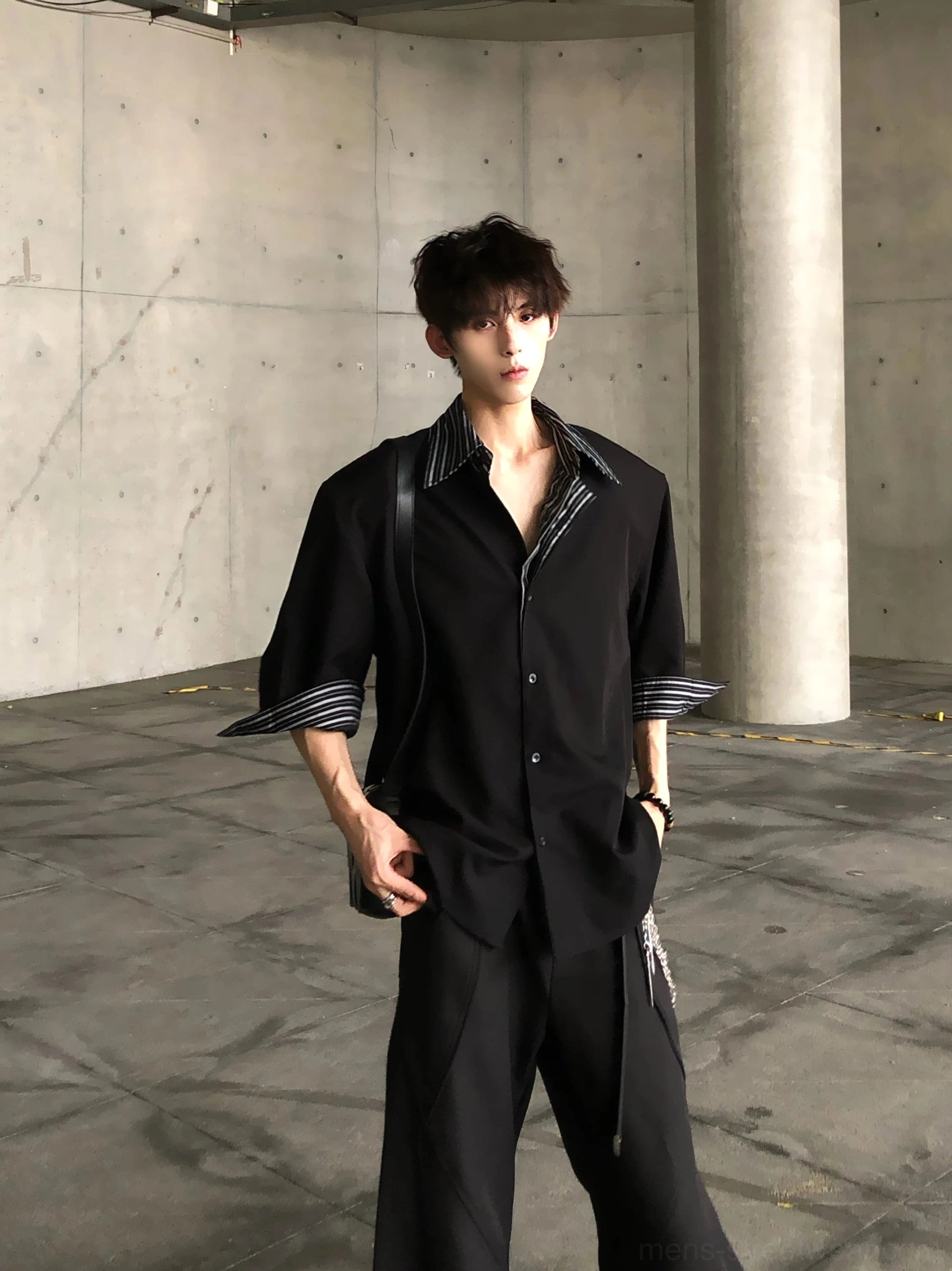 Three quarter full outfit view of black layered stripe collar oversized shirt with striped cuffs and monochrome streetwear styling