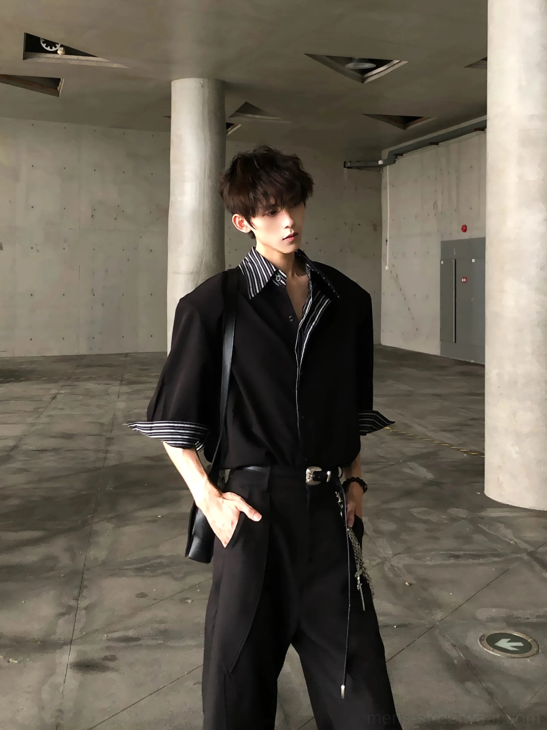 Side front view of black Korean streetwear shirt with contrast striped collar cuffs and relaxed boxy silhouette
