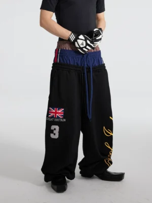 Black layered triple waist wide leg fleece track pants with graphic print and long drawstrings front outfit detail