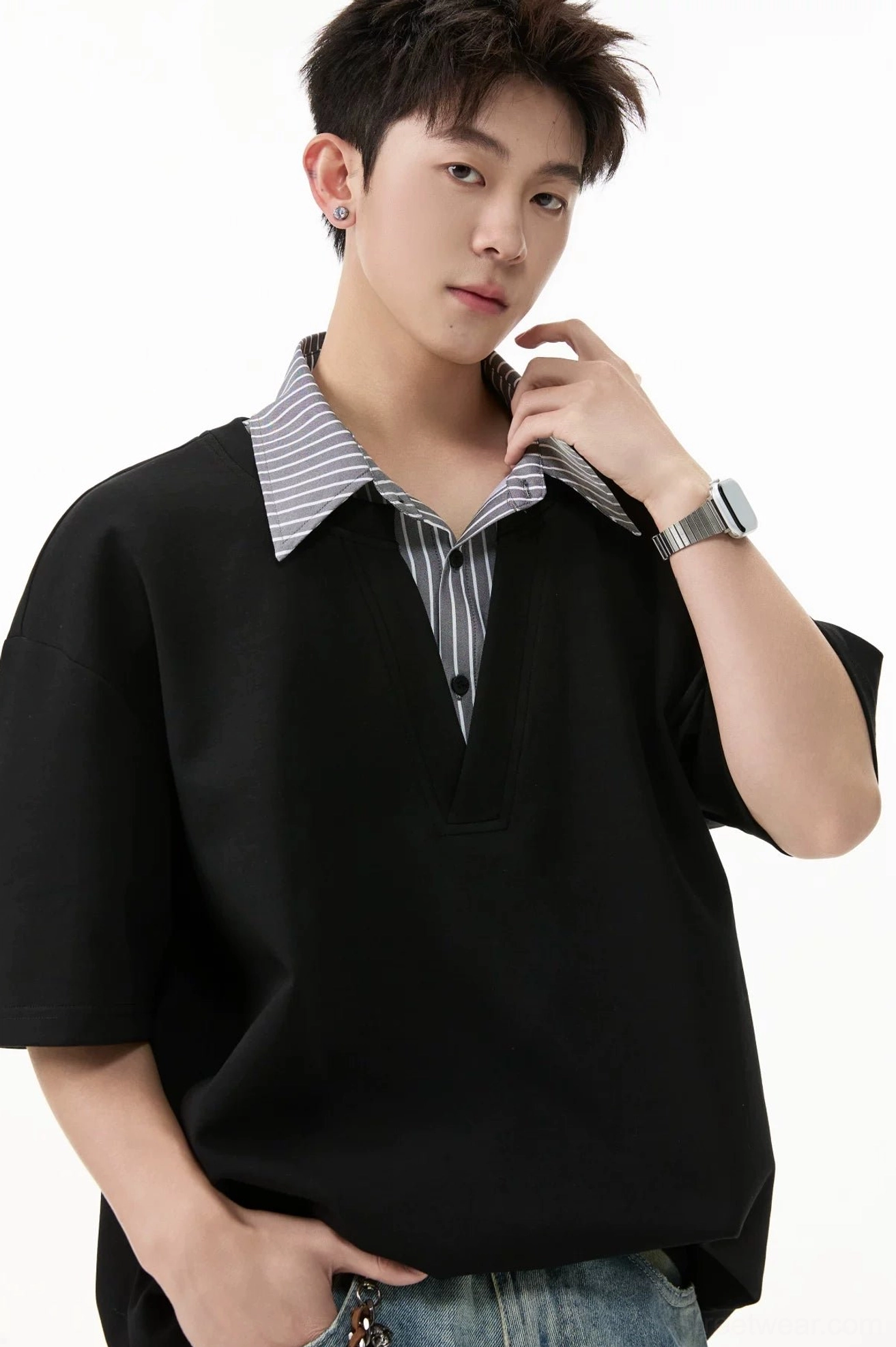 Black layered V-placket oversized polo tee close-up featuring contrasting striped collar insert and soft relaxed fabric