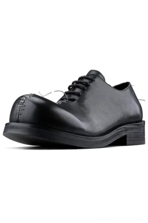 Black leather contrast stitch Oxford shoes in three-quarter side view with rounded toe, lace-up closure, white toe stitching, and rubber sole