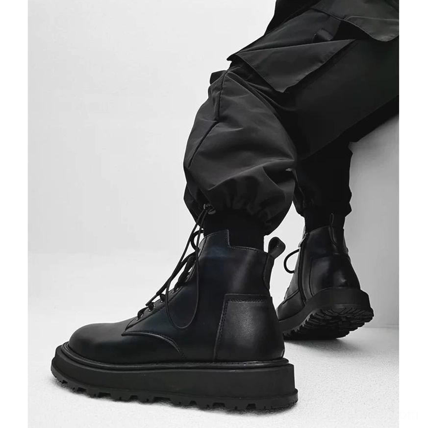 Black leather-look platform combat boots worn with cargo pants showing polished finish, rear pull tab and deep multi-directional traction tread