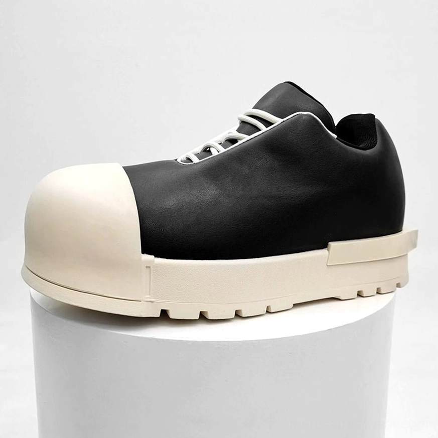 Black leather two-tone platform sneakers with oversized cream toe, thick lug sole, white laces, and bold Korean streetwear silhouette