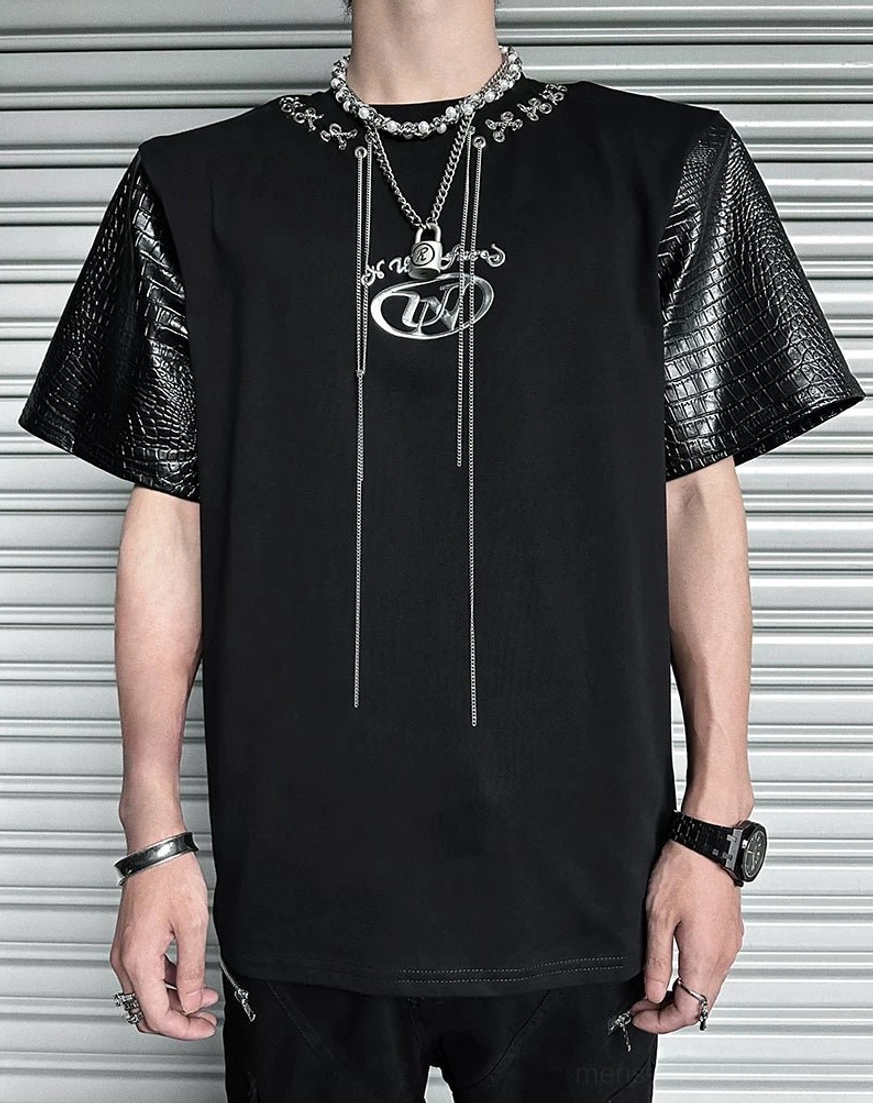 Full front view of black loose-fit chain lace panel T-shirt with crocodile-pattern faux-leather sleeves and long silver pendant chains