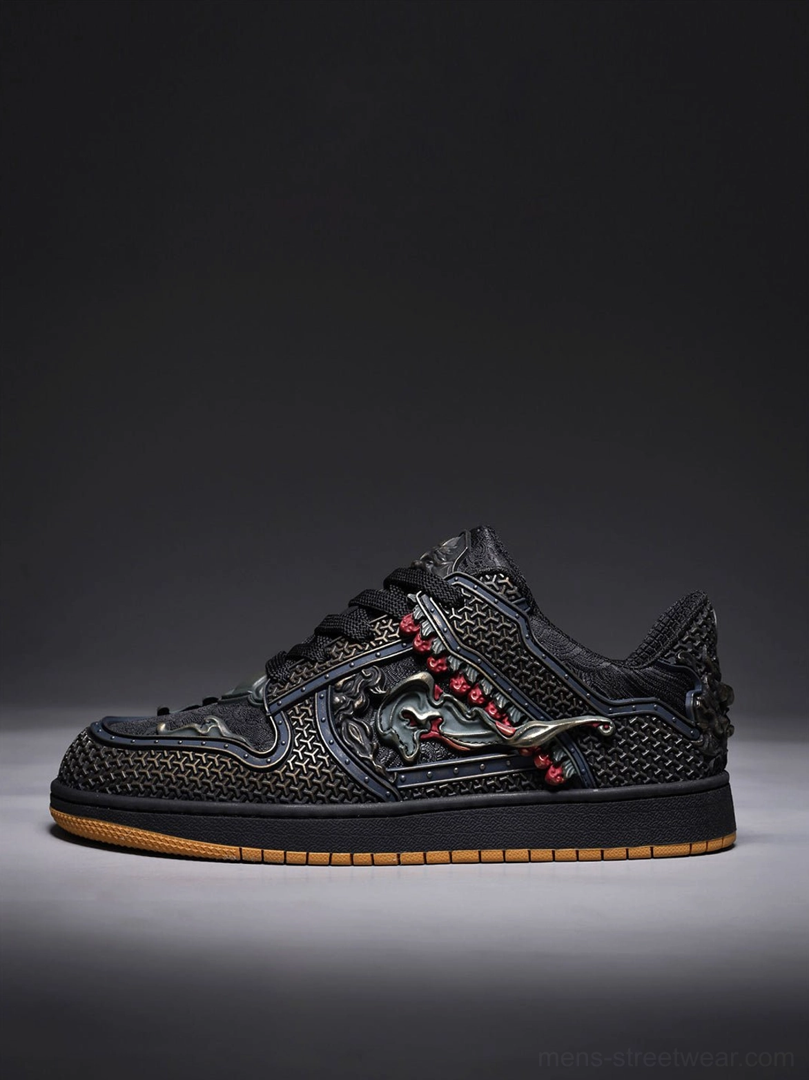 Side profile of black low-top dragon embroidered sneakers with bronze mythical detailing and red bead trim