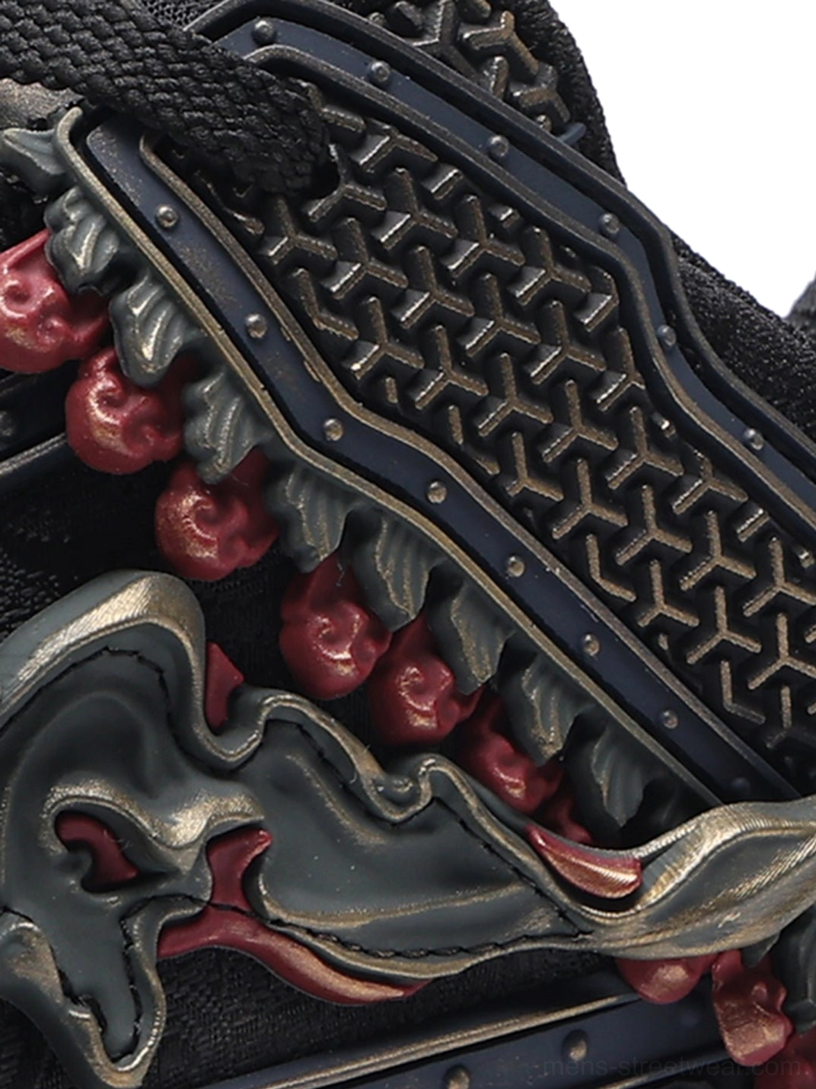 Black low-top dragon streetwear sneakers showcasing layered panels and statement embroidered detailing