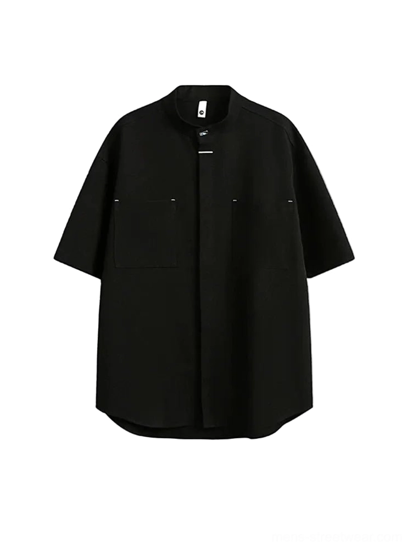 Black mandarin collar oversized utility shirt with concealed placket and dual chest pockets front view