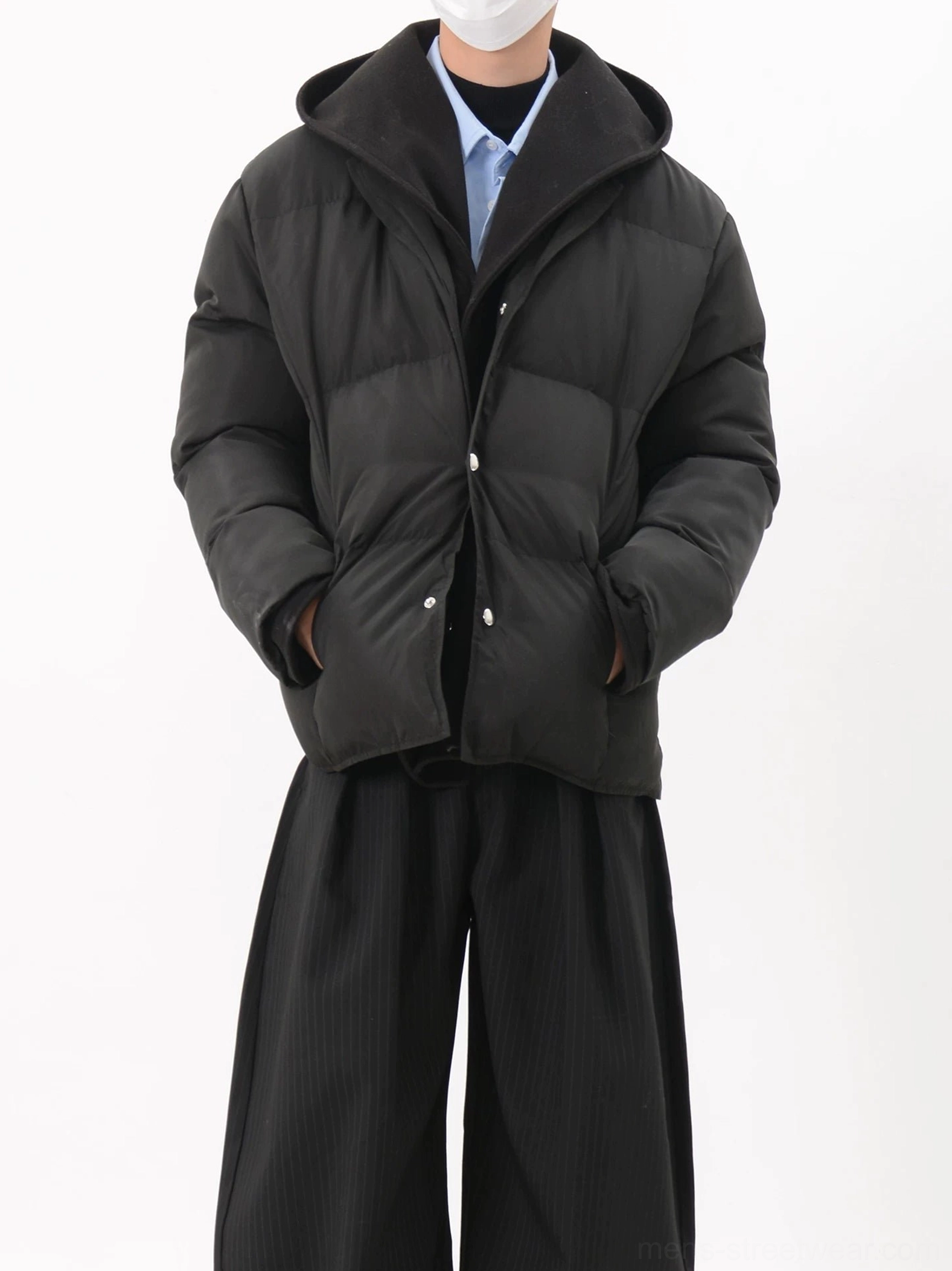 Black matte hooded snap-button puffer jacket side angle showing padded structure and spacious pocket