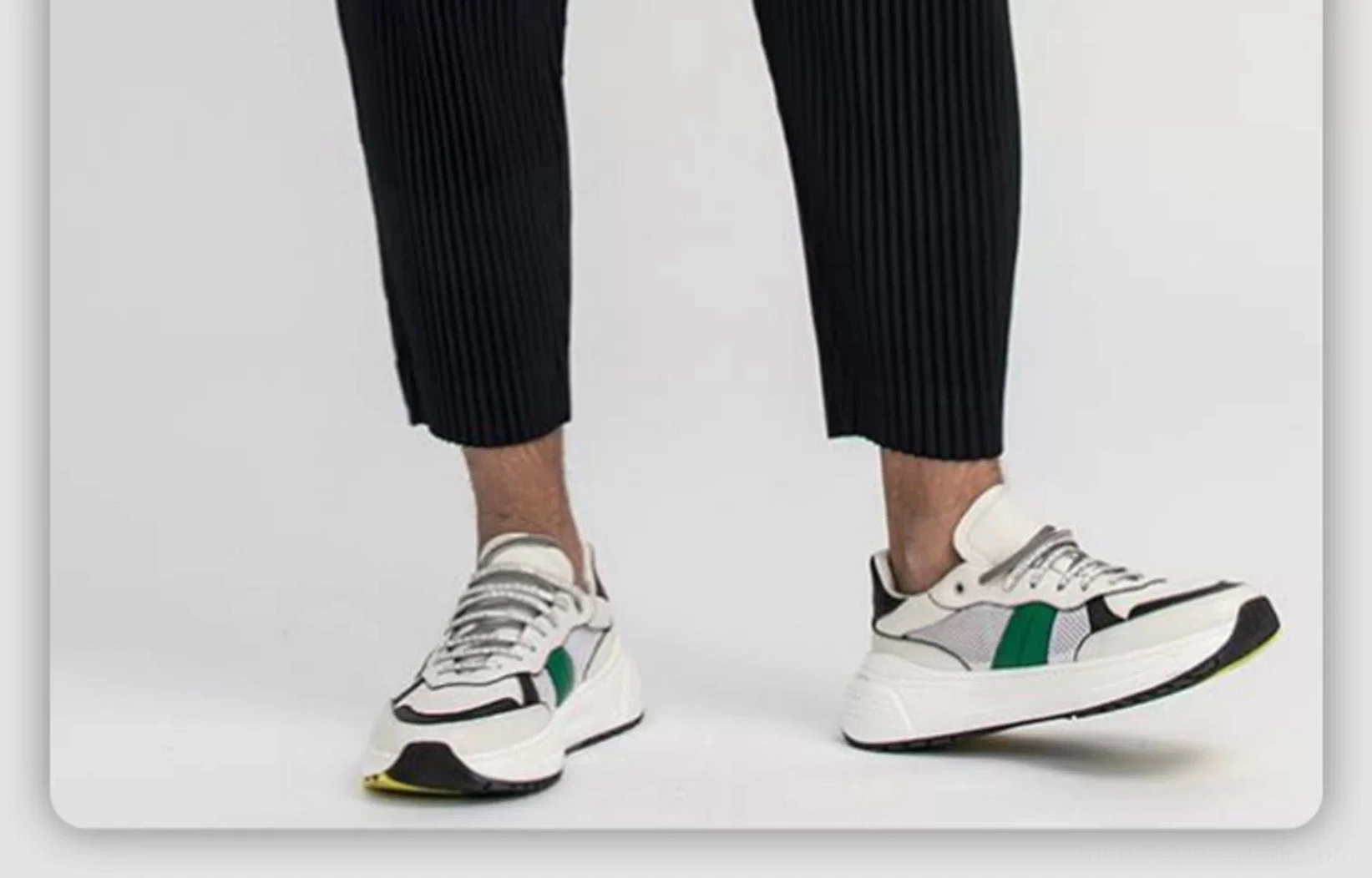 Black men's pleated cropped pants with fine vertical texture and color-block dad sneakers for contemporary Seoul streetwear styling