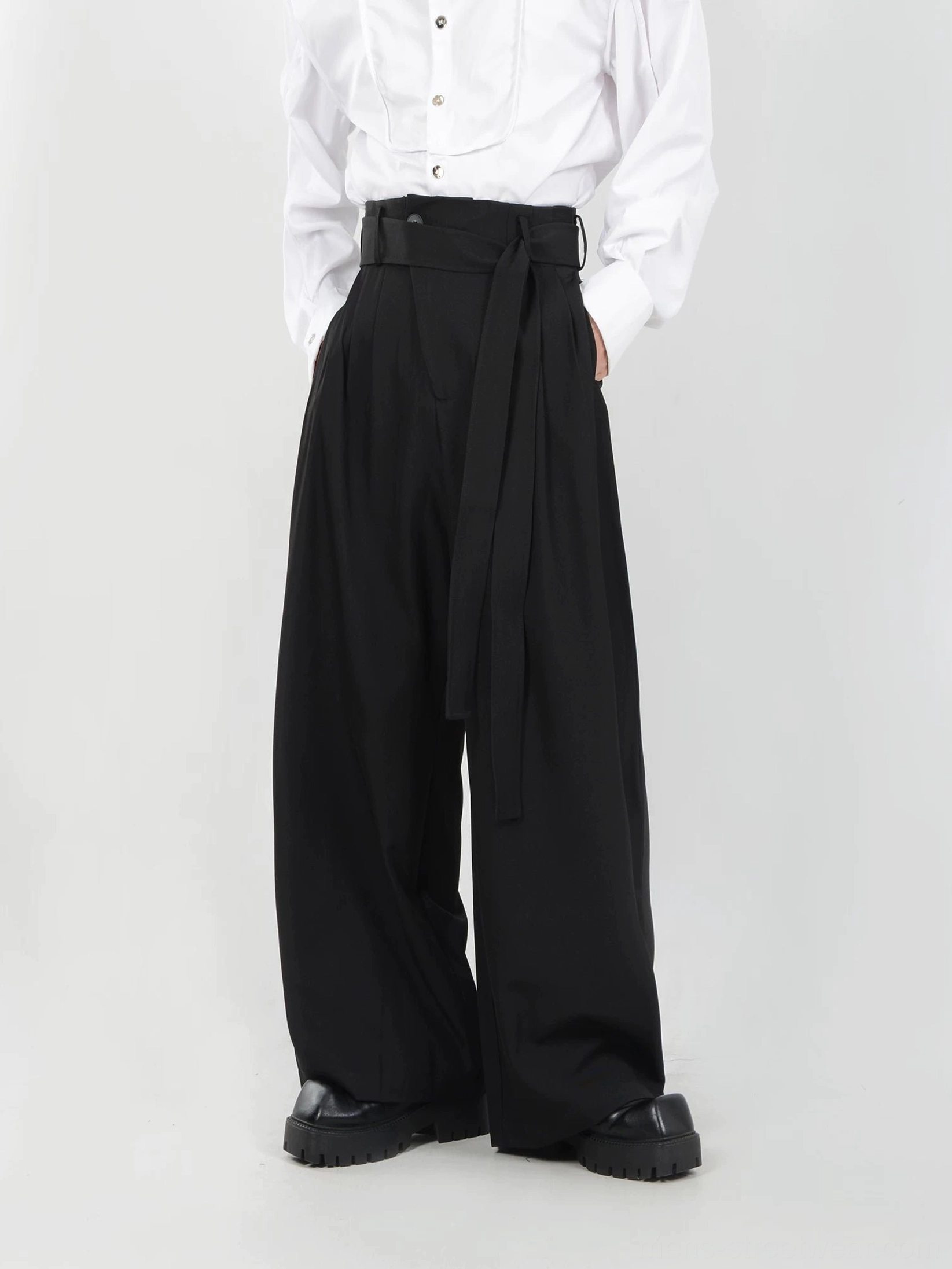 Black mens sash belt pleated wide-leg trousers front full-body view with high waist and floor-skimming straight legs