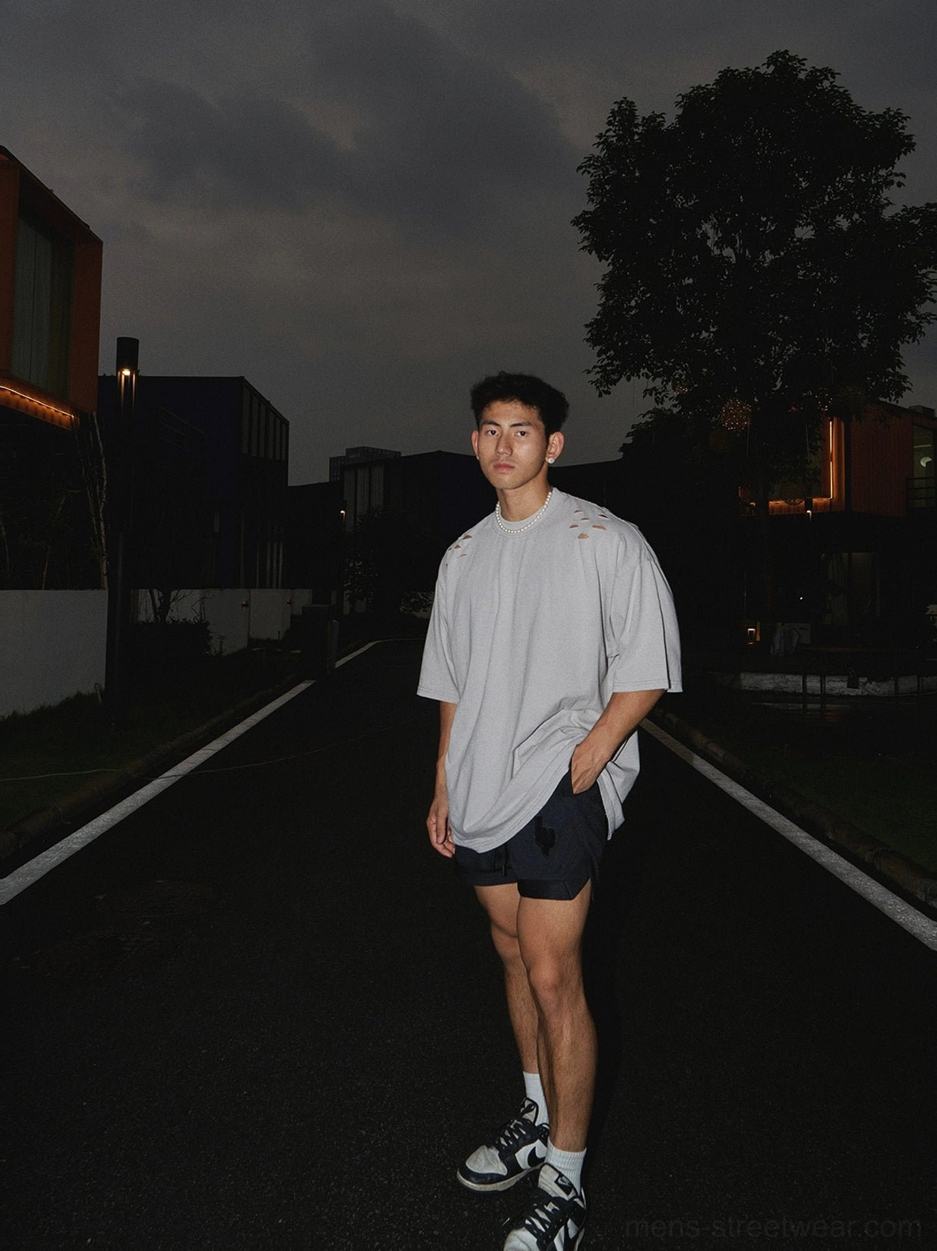 Black mesh athletic shorts paired with an oversized gray t-shirt in a casual relaxed streetwear outfit