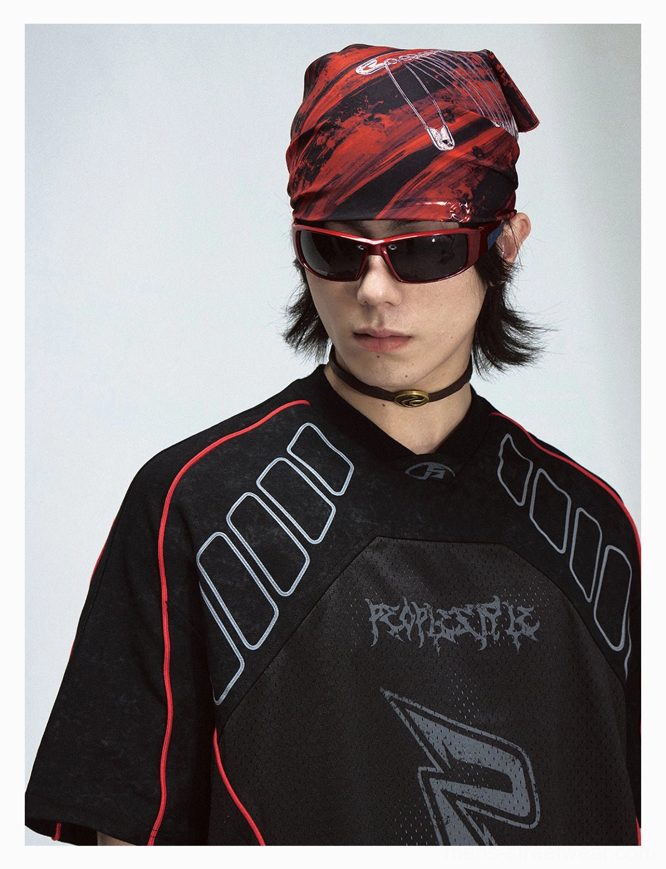 Close-up of black mesh graphic jersey T-shirt with red bandana, tinted sunglasses, choker styling, and detailed streetwear chest graphics