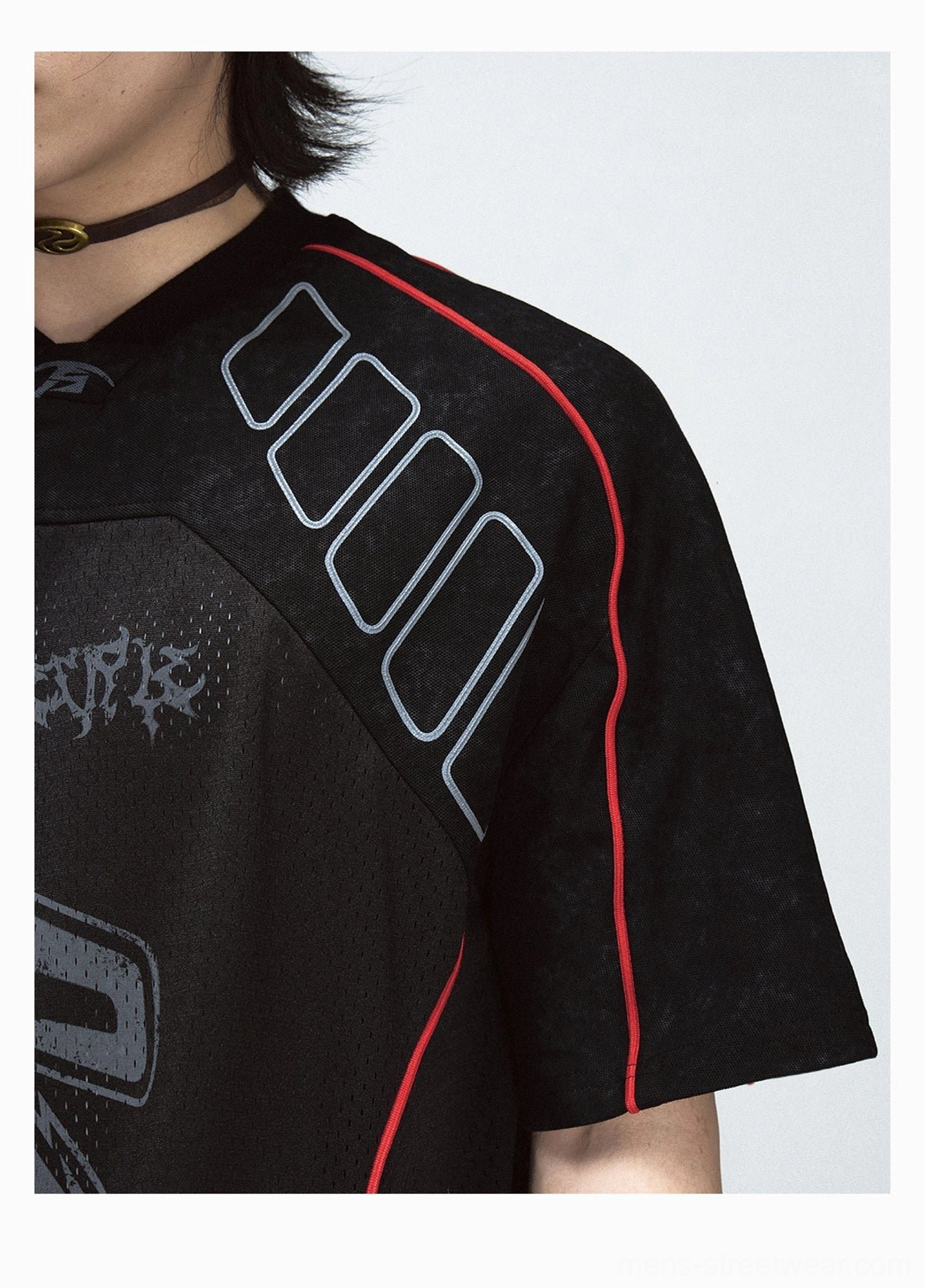 Detailed black mesh jersey T-shirt shoulder and chest view showing grey geometric trim, red piping, graffiti print, and P-shaped logo