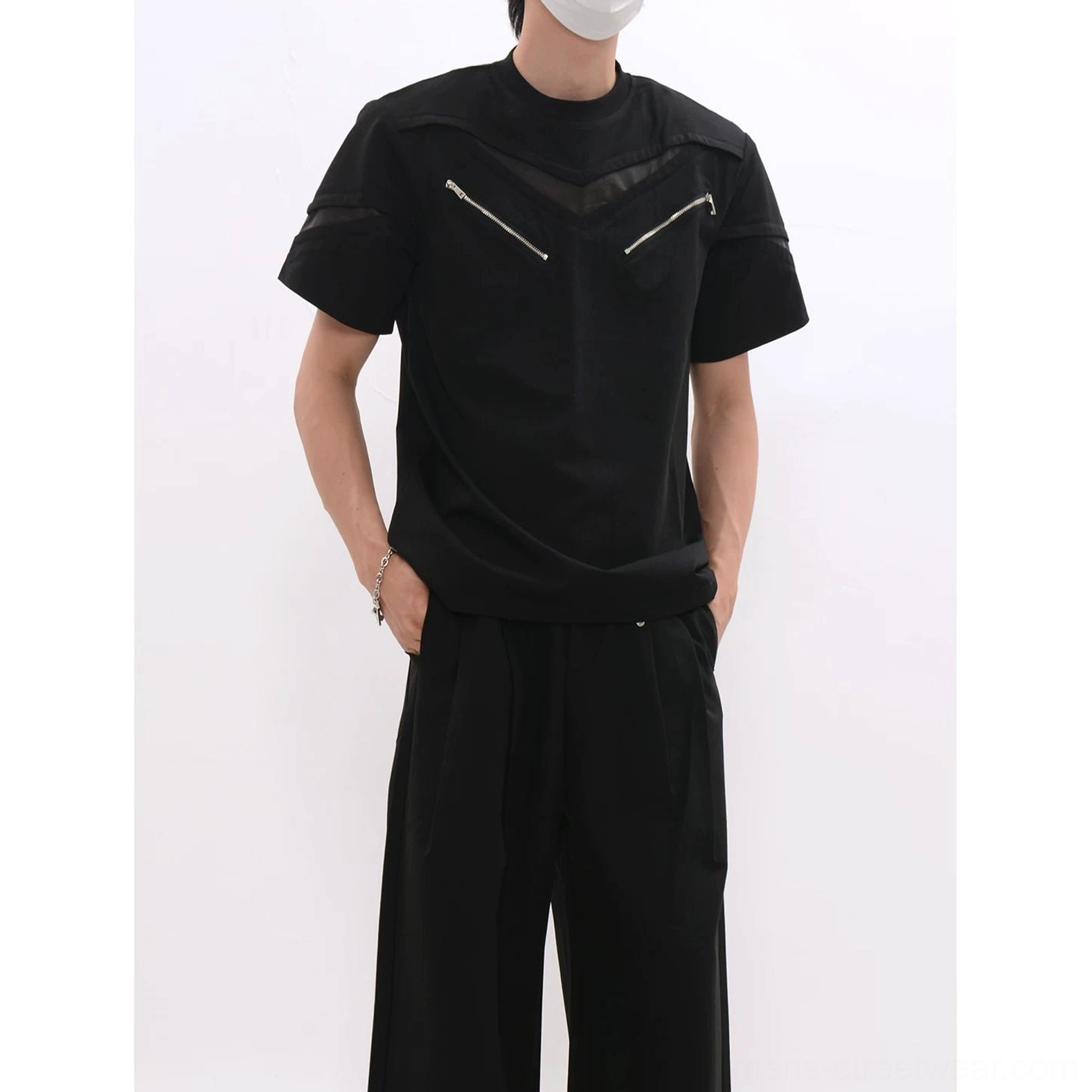 Close front view of black mesh zip panel techwear T-shirt showing dual chest zippers and textured upper panels
