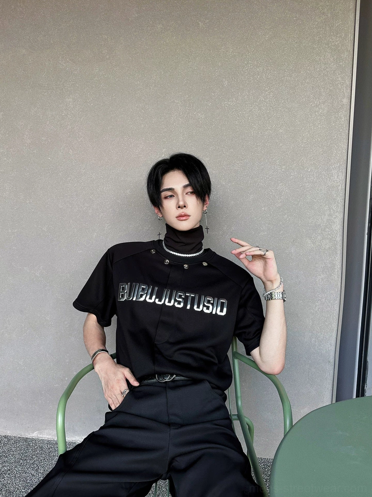 Black metallic snap-collar graphic tee with silver chest lettering shown in a clean product display view