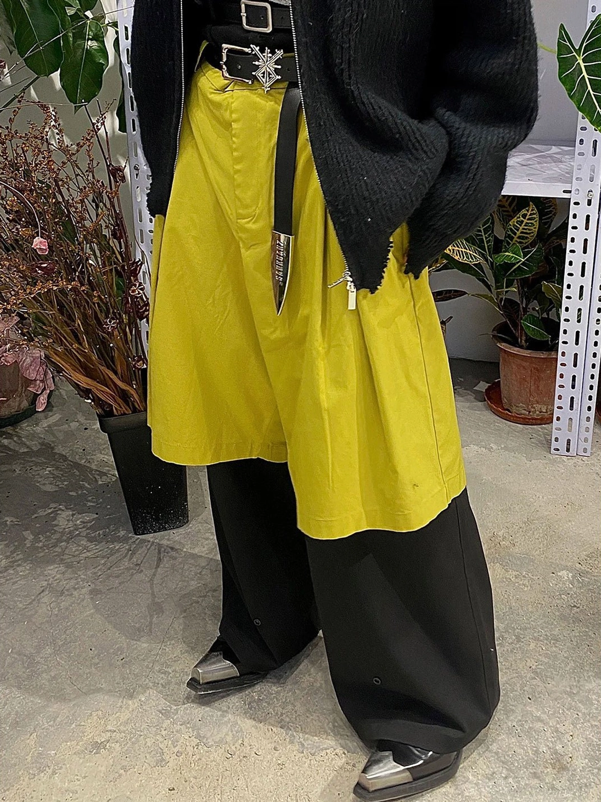 Black metallic toe block heel Chelsea boots styled with split wide leg pants and punk belt in a fashion outfit