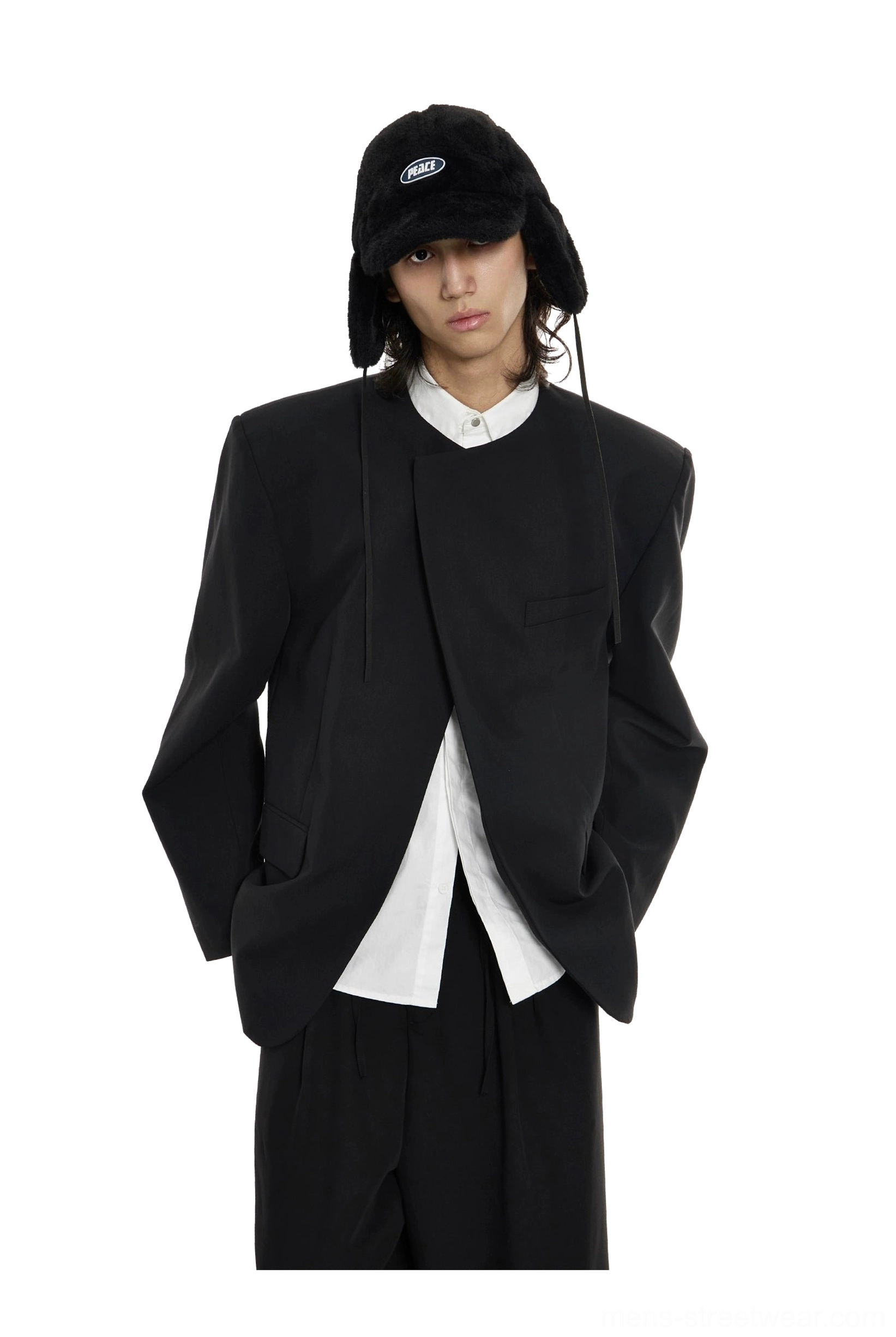 Close-up front view of black minimalist blazer with asymmetrical concealed front placket