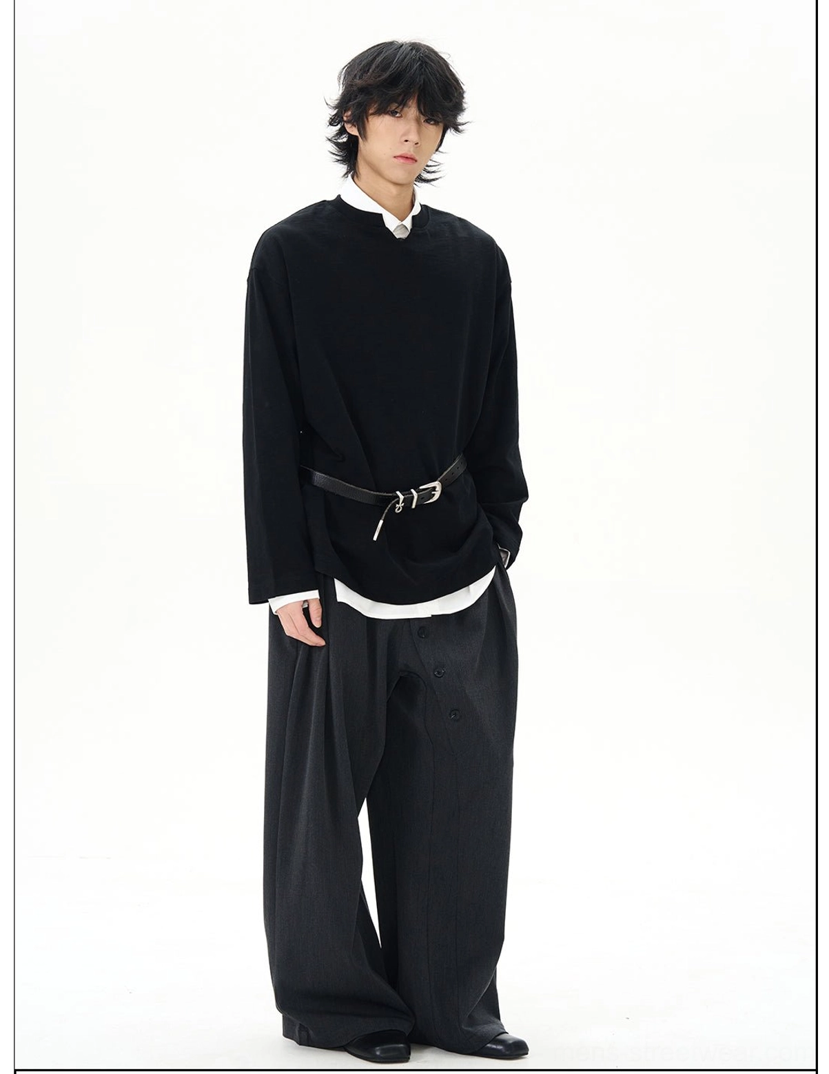 Three-quarter view of a black minimalist Korean streetwear long-sleeve top with layered white collar wide-leg trousers and leather belt