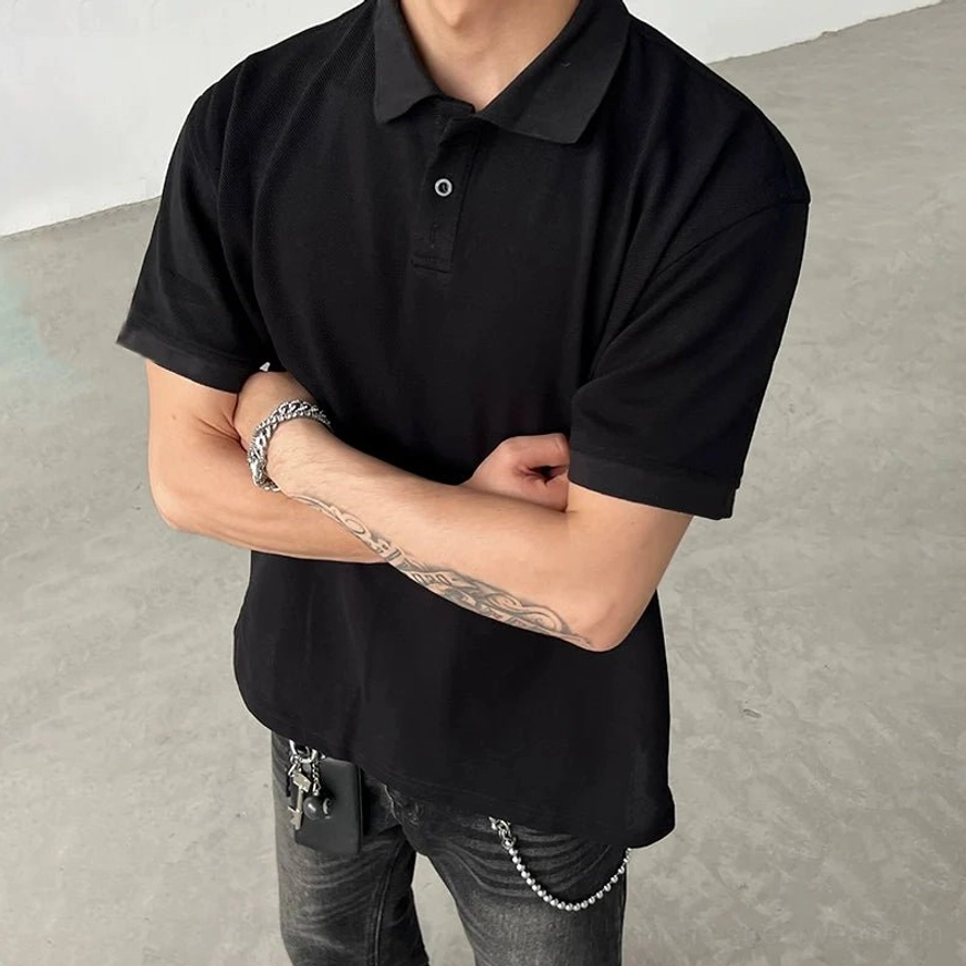 Black minimalist polo shirt with textured piqué-style fabric, classic collar, short sleeves, and button placket styled with silver bracelets for Korean streetwear