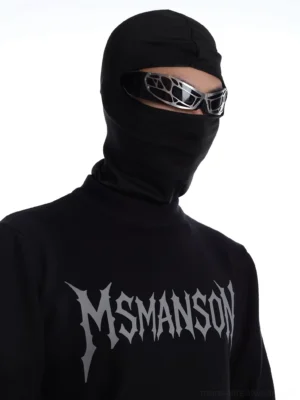Close up front view of black mock neck streetwear top showing silver grey gothic logo print high neckline and fine gauge knit texture