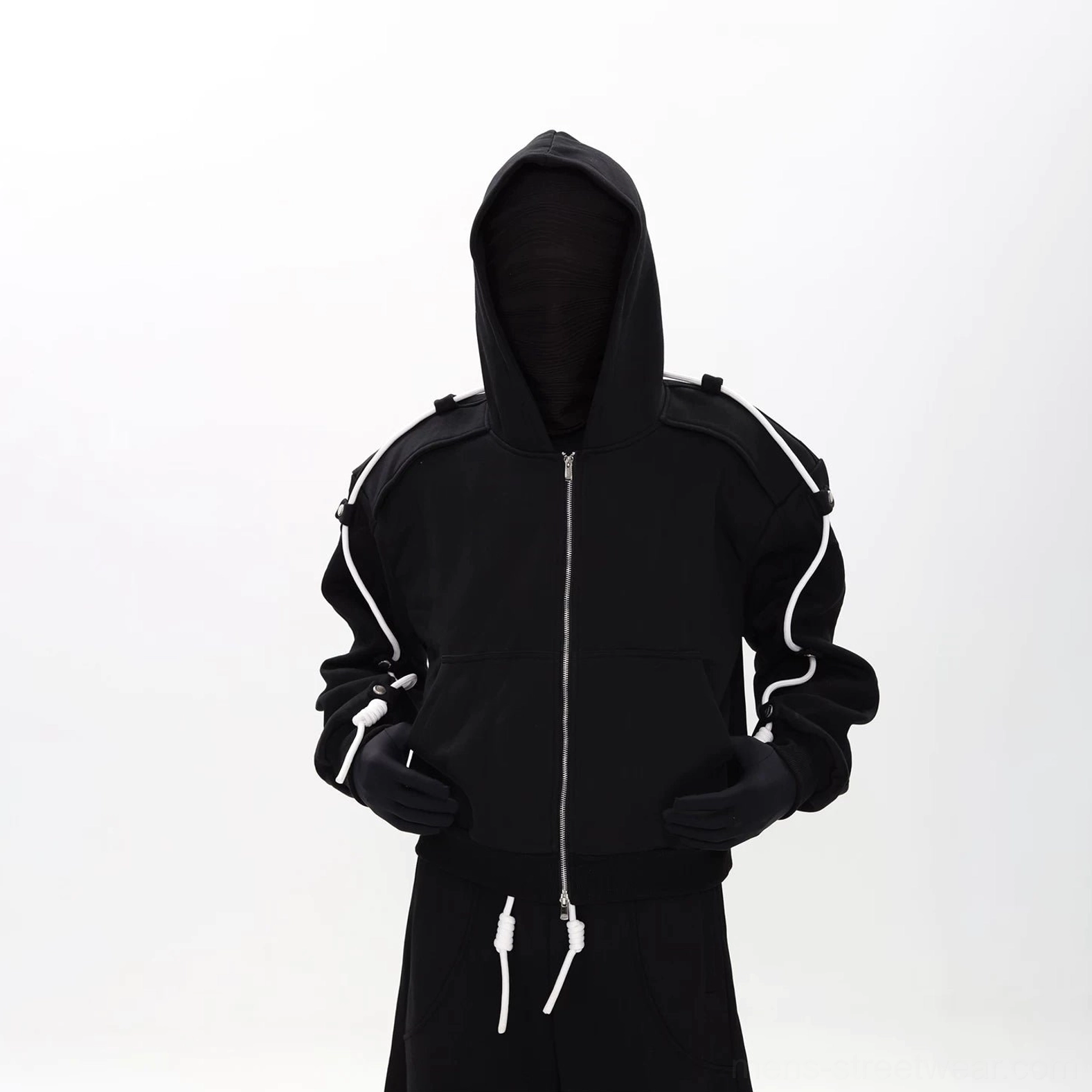 Close front view of black modular zip-up hoodie with metal zipper, three-dimensional hood, and contrast sleeve drawcords